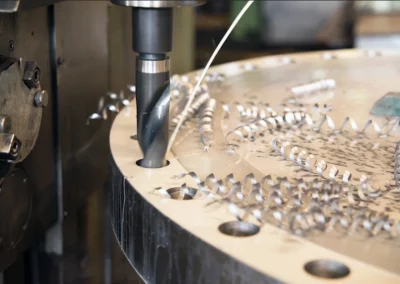 Our skilled team uses Mastercam programming to create precise and intricate milling and boring parts, such as this one being machined with a high-speed steel drill. Trust our CNC programming services for quality results with quick turnaround times, no matter the size or complexity of your project.